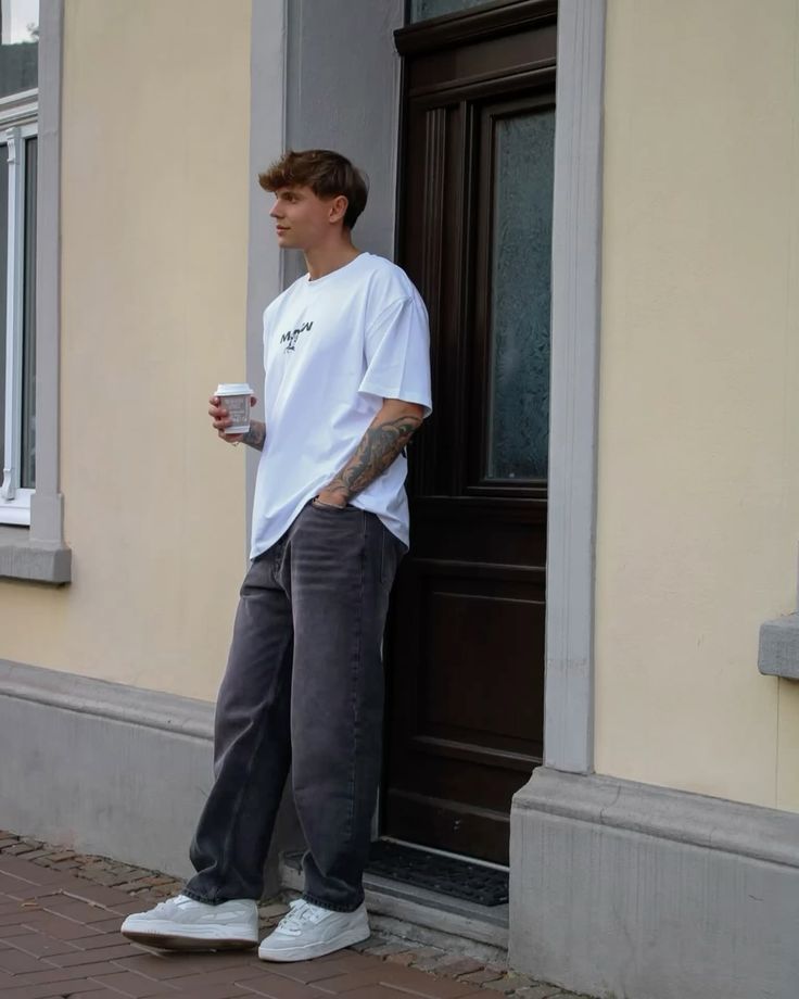 Young man in black streetwear outfit — UrbanVibe SS25 hero look
